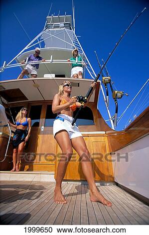 Hawaii, Big Island, Kona, Sport Fishing Stern Of Boat, Woman Standing, Reels In Fish, Others Watch View Large Photo Image Stock Image - Hawaii, Big Island, Kona, Sport Fishing Stern Of Boat, Woman Standing, Reels In Fish, Others Watch. Fotosearch