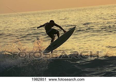 Hawaii, Big Island, Kona, Surfer At Sunset. View Large Photo Image Stock Image - Hawaii, Big Island, Kona, Surfer At Sunset.. Fotosearch