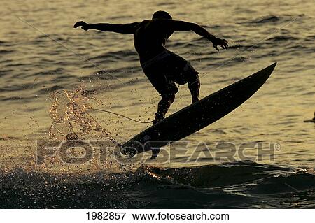 Hawaii, Big Island, Kona, Surfer At Sunset. View Large Photo Image Stock Photo - Hawaii, Big Island, Kona, Surfer At Sunset.. Fotosearch