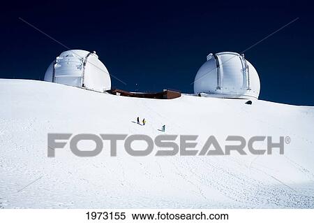Stock Photography - Hawaii, Big Island, Mauna Kea Observatory, Covered In Snow With Three Snowboarders Walking The Slope.. Fotosearch