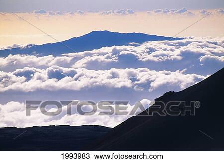 Stock Image - Hawaii, Big Island, Mauna Loa Observatories, Mauna Loa Shield Volcano, Surrounded By Cumulous Clouds.. Fotosearch