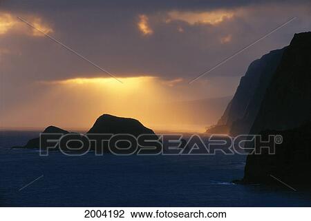Stock Image - Hawaii, Big Island, North Kohala Coast, Shoreline At Sunrise, Island Offshore, Orange Sunrays. Fotosearch