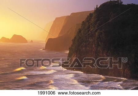 Stock Photograph - Hawaii, Big Island, North Kohala, Pololu Coast And Warm Glowing Surf Sunrise. Fotosearch