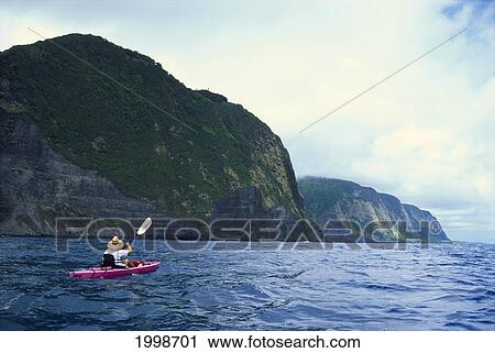 Stock Image - Hawaii, Big Island, North Shore, Along Coastline, Person Kayaking. For Editorial Use Only.. Fotosearch