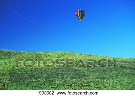 Stock Image - Hawaii, Big Island, Parker Ranch, Waiki'i, Colorful Hot Air Balloon.. Fotosearch