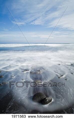 Stock Image - Hawaii, Big Island, Pololu, Black Sand Beach And Ocean Water, Long Exposure.. Fotosearch