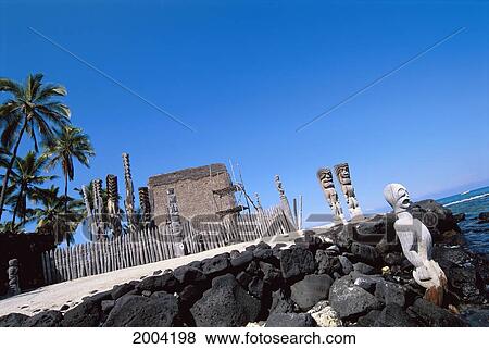 Stock Photo - Hawaii, Big Island, Puuhonua O Honaunau Far Away View Of Wooden Statues At Hale O Keawe Heiau. Fotosearch