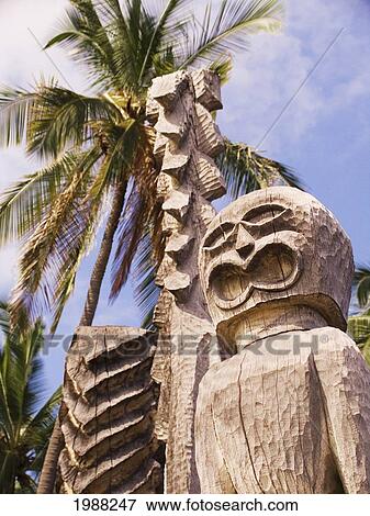 Hawaii, Big Island, Puuhonua O Honaunau, City Of Refuge, Ki'i Against Blue Sky And Palm Trees. View Large Photo Image Stock Photo - Hawaii, Big Island, Puuhonua O Honaunau, City Of Refuge, Ki'i Against Blue Sky And Palm Trees.. Fotosearch