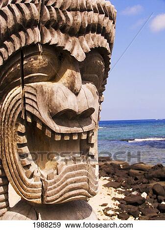 Stock Photo - Hawaii, Big Island, Puuhonua O Honaunau, City Of Refuge, Close-Up Of Ki'i In Front Of Blue Sky And Ocean.. Fotosearch