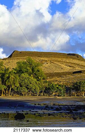 Stock Photo - Hawaii, Big Island, Pu'ukohola Heiau National Park, Scenic view of land, ocean and palm trees.. Fotosearch