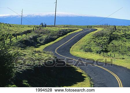 Stock Photo - Hawaii, Big Island, Saddle Road Curves It's Way Towards Snowcapped Mauna Loa.. Fotosearch