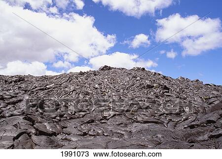 Stock Image - Hawaii, Big Island, Saddle Road, Pahoehoe Lava Field, Blue Skies, Clouds. Fotosearch