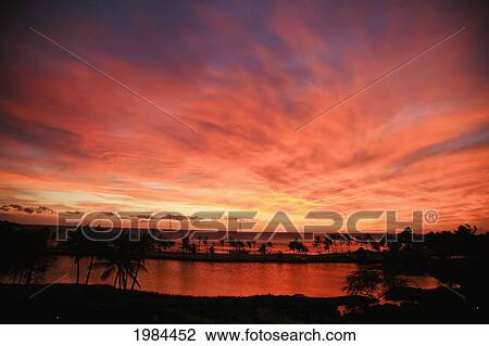 Stock Image - Hawaii, Big Island, South Kohala, Anaeho'omalu Bay, Dramatic And Vibrant Red Sunset Sky.. Fotosearch