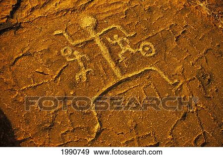 Stock Photo - Hawaii, Big Island, South Kohala. Petroglyph Man On Red Rock. Puako.. Fotosearch