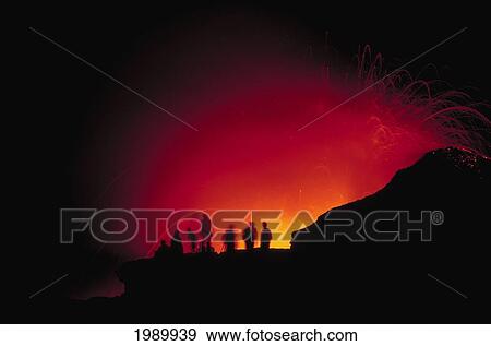 Stock Photo - Hawaii, Big Island, Visitors View A Glowing Explosion Of Lava At Night. Fotosearch
