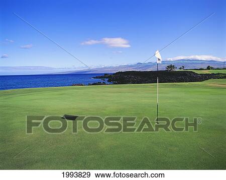 Stock Photo - Hawaii, Big Island, Waikoloa Resort Golf Course, Beach Course, Golf Ball And Flag.. Fotosearch