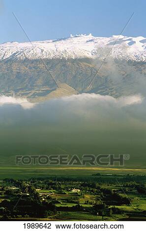 Stock Image - Hawaii, Big Island, Waimea Town And Snowcapped Mauna Kea And Observatories. Fotosearch