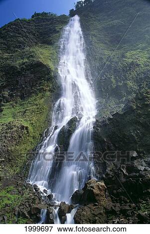 Stock Photo - Hawaii, Big Island, Waipio Valley, Kaluahine Falls With Rushing Water Action, Blue Sky C1652. Fotosearch