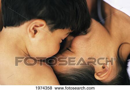 Stock Photo - Hawaii, Brother And Sister Laying On The Ground.. Fotosearch