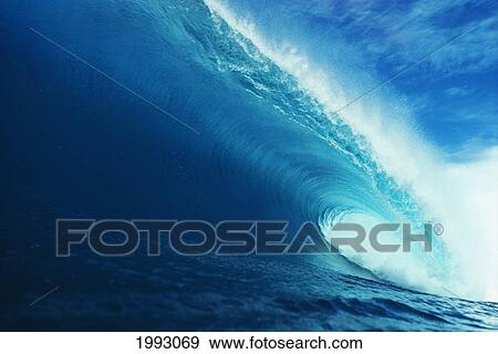 Stock Photo - Hawaii, Close-Up View Of Big Blue Tube, Sky And Clouds.. Fotosearch