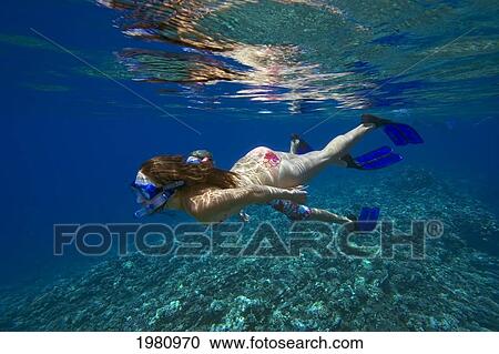 Stock Image - Hawaii, Couple Free Diving Over Coral Reef.. Fotosearch