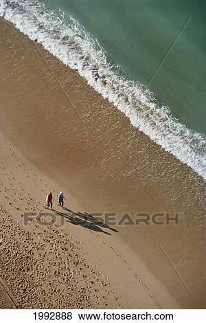 Hawaii, Couple Walking On Beach In The Afternoon, View From Above. View Large Photo Image Stock Photo - Hawaii, Couple Walking On Beach In The Afternoon, View From Above.. Fotosearch