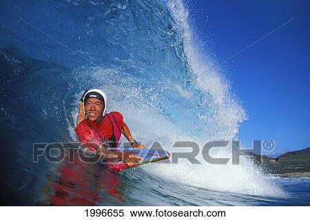 Stock Photography - Hawaii, Danny Kim With Helmet And Red Rash Guard Body Boards In The Tube As Wave Curls.. Fotosearch