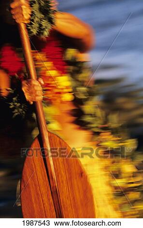 Stock Image - Hawaii, Detail Of Hands Holding Wooden Paddle, Blurred Background.. Fotosearch