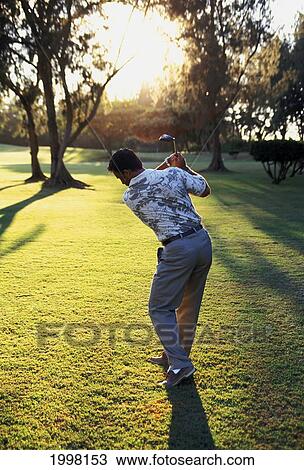 Hawaii, Golfer In About To Swing Showing Form. Dramatic Light. View Large Photo Image Stock Image - Hawaii, Golfer In About To Swing Showing Form. Dramatic Light.. Fotosearch