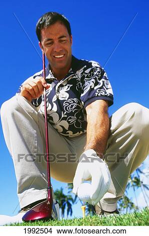 Hawaii, Golfer Sets Up His Shot, View From Below. View Large Photo Image Picture - Hawaii, Golfer Sets Up His Shot, View From Below.. Fotosearch