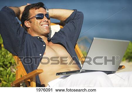 Hawaii, Handsome Man Sitting On Beach With Laptop Computer. View Large Photo Image Stock Image - Hawaii, Handsome Man Sitting On Beach With Laptop Computer.. Fotosearch