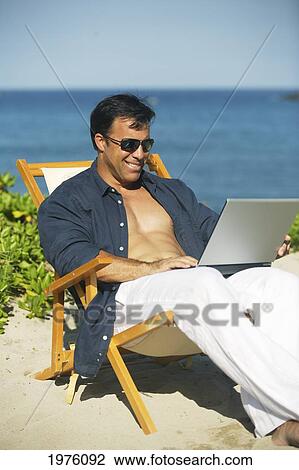 Hawaii, Handsome Man Sitting On Beach With Laptop Computer. View Large Photo Image Stock Image - Hawaii, Handsome Man Sitting On Beach With Laptop Computer.. Fotosearch