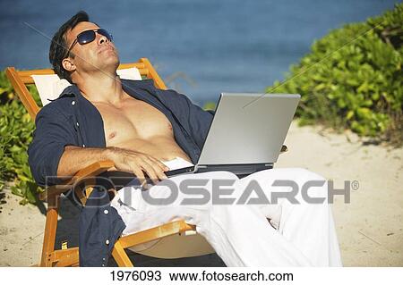 Hawaii, Handsome Man Sitting On Beach With Laptop Computer. View Large Photo Image Stock Image - Hawaii, Handsome Man Sitting On Beach With Laptop Computer.. Fotosearch