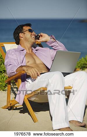 Stock Photo - Hawaii, Handsome Man Sitting On Beach With Laptop Computer.. Fotosearch