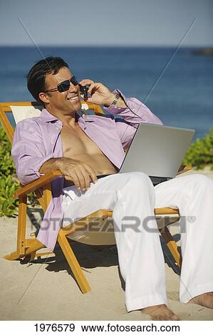 Hawaii, Handsome Man Sitting On Beach With Laptop Computer. View Large Photo Image Stock Photo - Hawaii, Handsome Man Sitting On Beach With Laptop Computer.. Fotosearch