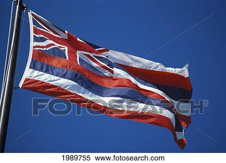 Stock Photography - Hawaii, Hawaiian Flag Blowing In The Wind Against Deep Blue Sky. Fotosearch