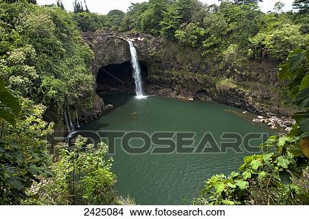 Picture - Hawaii, Hilo, Rainbow Falls surrounded by lush greenery.. Fotosearch