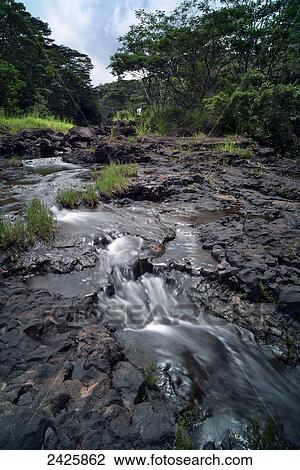 Stock Image - Hawaii, Hilo, Rainwater flows through Boiling Pots Park.. Fotosearch