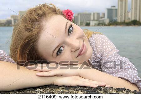 Stock Photo - Hawaii, Honolulu, Portrait of a beautiful young redhead woman.. Fotosearch