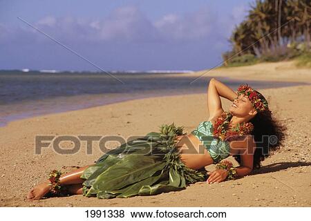 Hawaii, Hula Girl Laying On The Beach In A Ti-Leaf Skirt View Large Photo Image Stock Photo - Hawaii, Hula Girl Laying On The Beach In A Ti-Leaf Skirt. Fotosearch