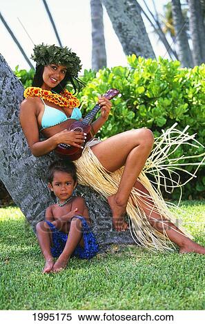 Stock Photography - Hawaii, Hula Girl With Haku And Ukulele Leaning Against Tree With Little Hawaiian Boy. Fotosearch