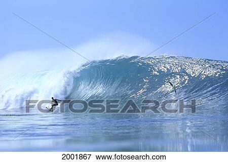 Stock Photo - Hawaii, Jason Magallanes Surfing Crystalline Curling Wave, Pale Blue Skies. Fotosearch