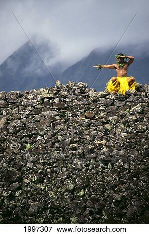 Hawaii, Kane (Male) Hula Dancer At Heiau Atop Rock Wall, Misty Sky Background A37D View Large Photo Image Stock Photo - Hawaii, Kane (Male) Hula Dancer At Heiau Atop Rock Wall, Misty Sky Background A37D. Fotosearch