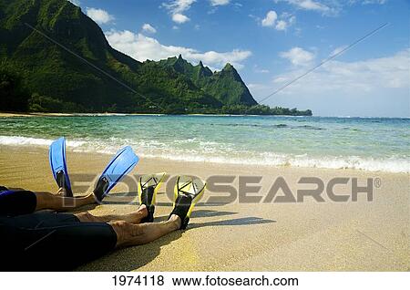 Stock Photo - Hawaii, Kauai, A Couple Wearing Yellow And Blue Fins On Beach.. Fotosearch