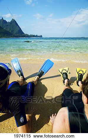 Stock Photography - Hawaii, Kauai, A Couple Wearing Yellow And Blue Fins On Beach.. Fotosearch