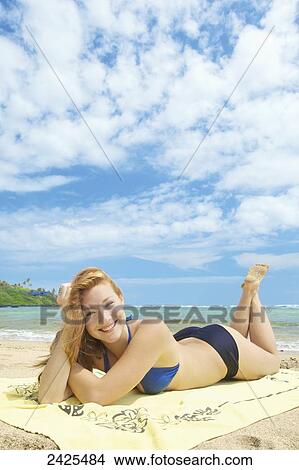 Hawaii, Kauai, A girl laying out at the beach. View Large Photo Image Picture - Hawaii, Kauai, A girl laying out at the beach.. Fotosearch