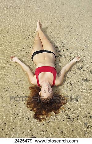 Hawaii, Kauai, A redheaded woman laying in the water. View Large Photo Image Stock Photo - Hawaii, Kauai, A redheaded woman laying in the water.. Fotosearch