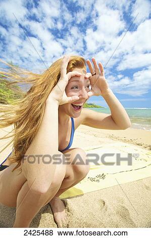 Hawaii, Kauai, a young woman pretends to wear goggles. View Large Photo Image Stock Photo - Hawaii, Kauai, a young woman pretends to wear goggles.. Fotosearch