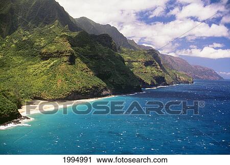 Stock Image - Hawaii, Kauai, Aerial Along Napali Coastline, Green Cliffs Secluded Beaches. Fotosearch