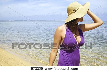Hawaii, Kauai, Anini Bay, Woman Walking The Beach With A Purple Dress On. View Large Photo Image Stock Photo - Hawaii, Kauai, Anini Bay, Woman Walking The Beach With A Purple Dress On.. Fotosearch